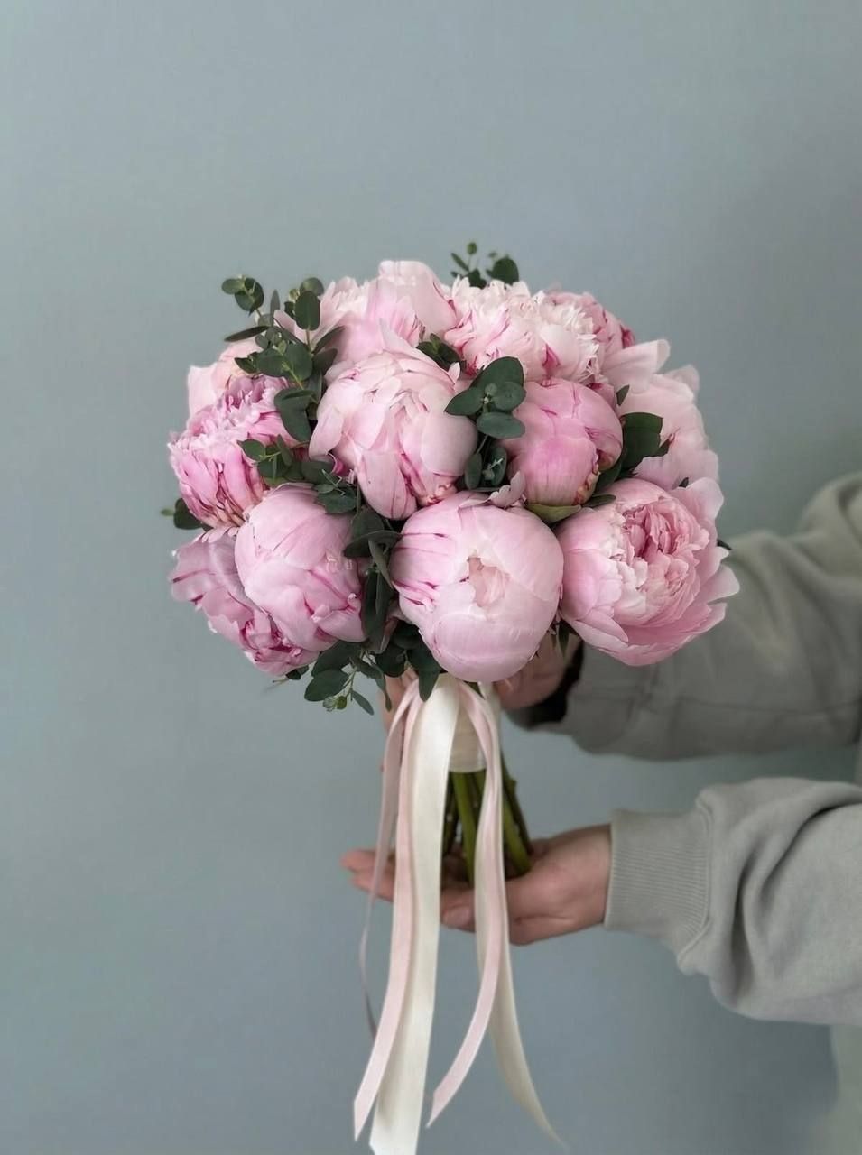 Bridal bouquet of pink peonies with eucalyptus